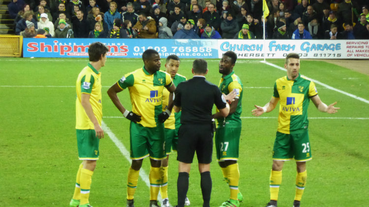 Norwich players contest a refereeing decision